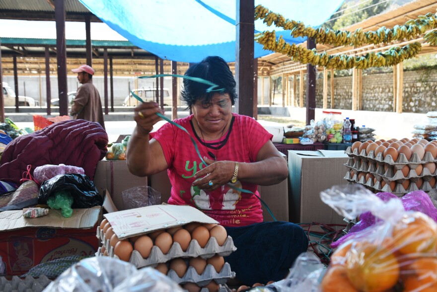 Pansang Dema, 61, sits among her eggs and produce and praises the king for granting her 5 acres of land 19 years ago. A mother of seven, she's "very happy" that she can "distribute all my land holdings to my children equally."