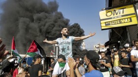 Protesters block the main road outside the Palestinian refugee camp of Burj al-Barajneh, south of the Lebanese capital Beirut, on July 16. The protests are against Lebanese government decision to restrict Palestinians' work opportunities.