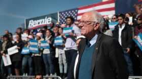 Democratic presidential candidate Sen. Bernie Sanders (I-VT) listens as Rev. Jesse Jackson addresses the crowd during Sander's campaign rally in Calder Plaza in Grand Rapids, Michigan.
