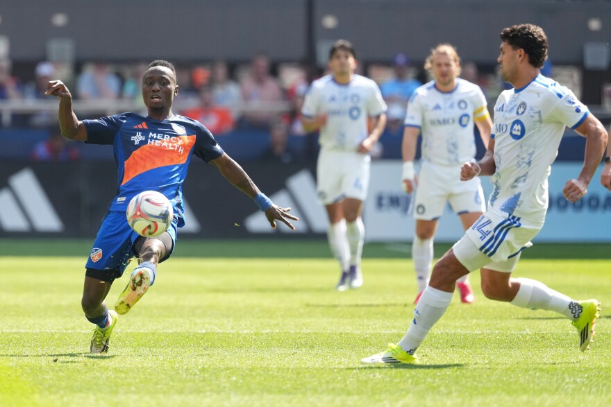 soccer players mid-play on a field