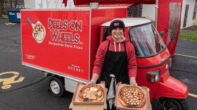 Luis Perez with a couple of Neapolitan pizza pies outside his Peels on Wheels Piaggio Ape