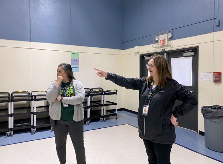 Yaquina View Elementary School principal Kristin Tocano Becker, left, and Lincoln County School District Communications Coordinator Kristin Bigler inside the current Yaquina View gym. The gym currently serves as a cafeteria and gym for students at the school.