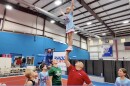 A RADD Sports student balances during a stunt at the group's gym.