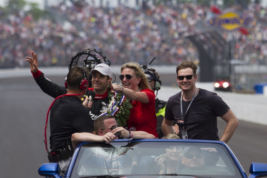 Will Power waves to the crowd with his wife, Elizabeth, during the victory lap after winning the Indianapolis 500 on Sunday.