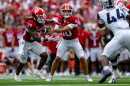 Indiana quarterback Josh Hoover (10) hands the ball off to running back Lee Beebe Jr. (29) during the first half an NCAA college football game against Howard, Saturday, Sept. 12, 2026, in Bloomington.