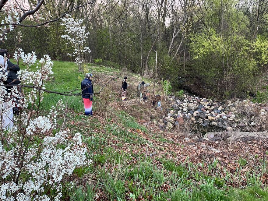 Siobhan Marks and other women of the group laying tobacco and collecting river water to carry along the walk.