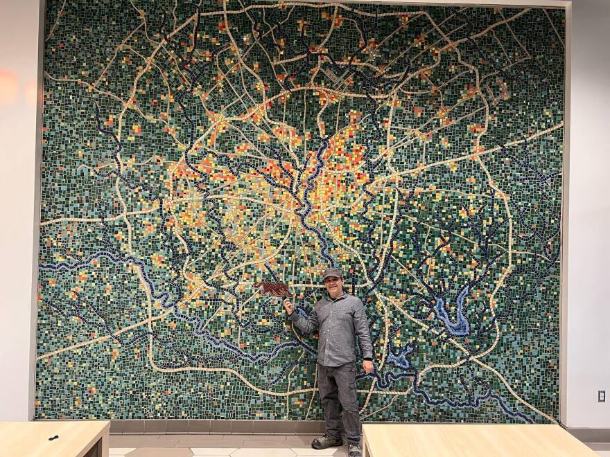 Oscar Alvarado with his 14' X 17' mural at Texas A&M San Antonio