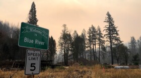 A sign welcomes people to Blue River, Oregon which was leveled by 2020's Holiday Farm Fire.
