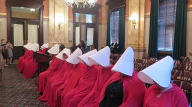 In June 2017, protestors dressed in costumes from the dystopian TV series "The Handmaid's Tale" sit in a committee hearing to oppose a bill banning a common procedure used in second-trimester abortions.