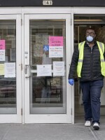 A worker leaves the the Frank P. Zeidler Municipal Building in Milwaukee late last month. Gov. Tony Evers has suspended in-person voting in the state's primary, which was scheduled for Tuesday April 7.