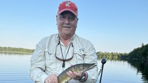 Hanover Delegate Buddy Fowler, author of the bill to expand free fishing days, holds a fish he's caught. 