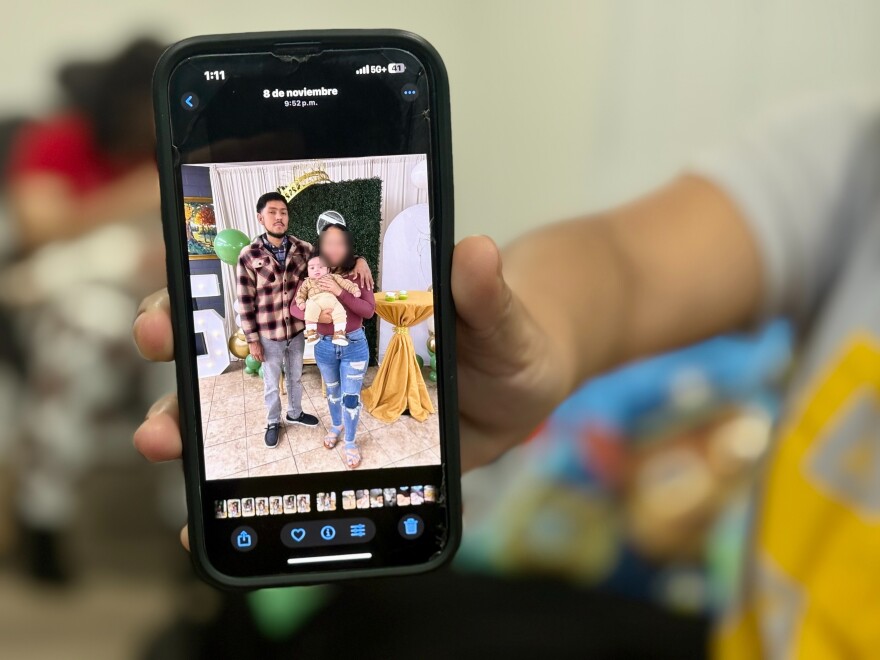 A relative shows a photo of Williams Javier Toro Enamorado with his partner and their newborn son.