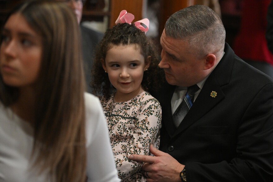 Capt. Michael Boyle talks to his youngest daughter Casey, 6, before being sworn in as Wilkes-Barre's new police chief. 