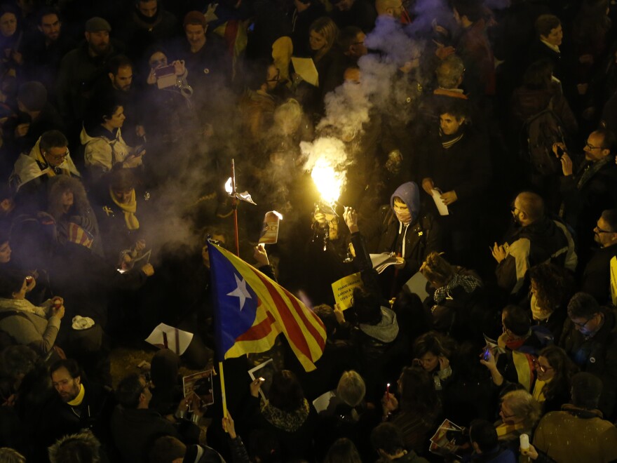 Portesters burn a photo of Spain's Prime Minister Mariano Rajoy during a protest over the jailing of Catalan politicians in Barcelona on Friday.