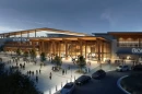 In this artist's rendering, a large white and tan building stands at dusk, lit up inside and out. "Eagles Arena" is emblazoned across the top of the building, also lit up. The concrete walkways and a paved traffic loop are bustling with activity.