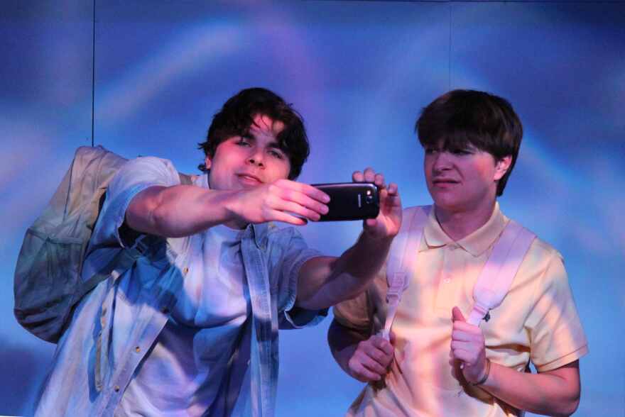 Liam Tritaik and William Urban play cousins standing in front of Robert Rauschenberg's 'Riding Bikes' sculpture in Berlin.