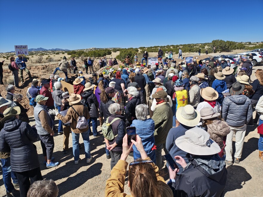 Hundreds of Protesters athered outside of the 10,000 acres of the former Zorro Ranch on Sunday, march 8, 2026, International Women's Day, demanding justice for survivors and accountability for perpetrators. The main compound of the ranch can be seen in the distance.