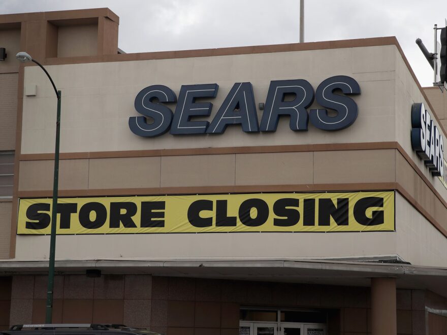 A sign announcing the store will be closing hangs above a Sears store on Aug. 24 in Chicago. Sears Holdings, which owns Sears and Kmart, said Thursday it was planning to close another 103 stores.