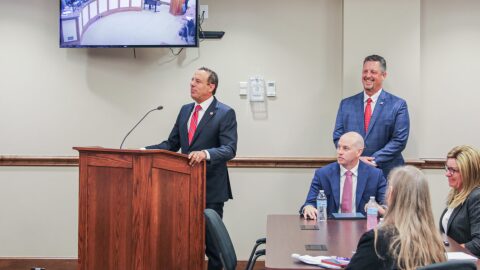 University of Oklahoma President Joseph Harroz, Jr., speaks Tuesday to the Oklahoma Turnpike Authority as OTA Executive Director Joe Echelle, standing right, looks on.