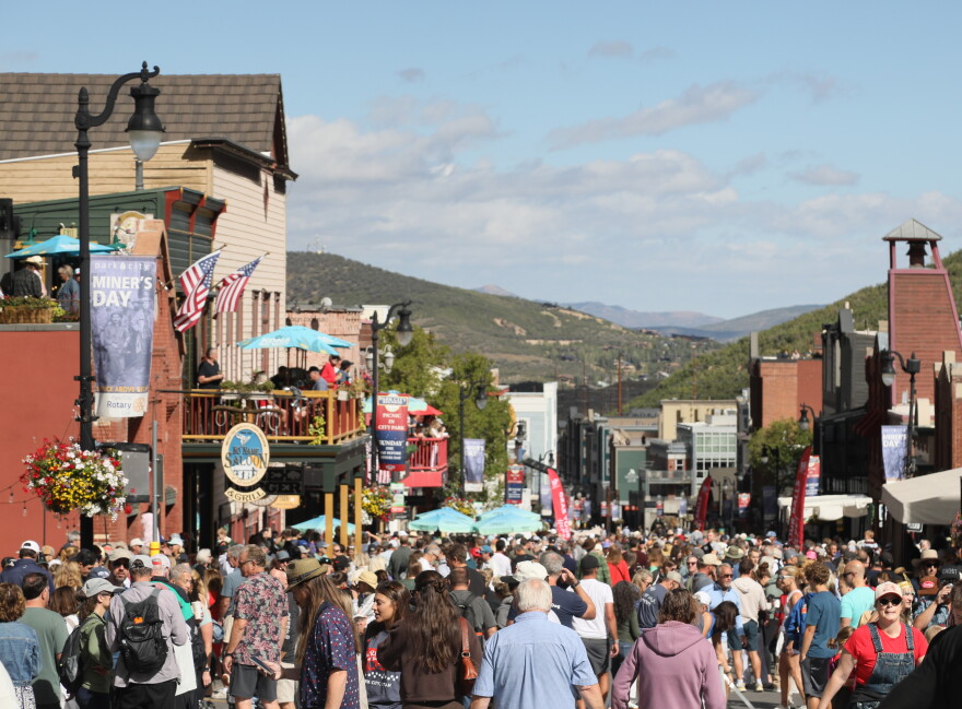 Crowds walk down Park City Main Street after the 2026 Miners Day Parade.