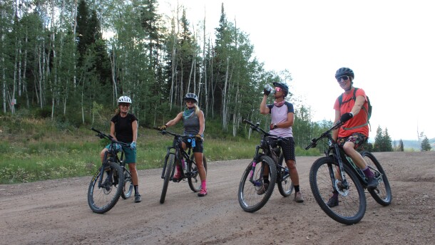 Members of the Girls Outside mountain biking group take a quick break during a ride on the Expresso trail near Snowmass Village on Aug. 4, 2026.