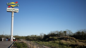 A portion of fence line for the 477 acres swapped to Texas Parks and Wildlife sits at a Stripes convenience store in Laguna Vista.