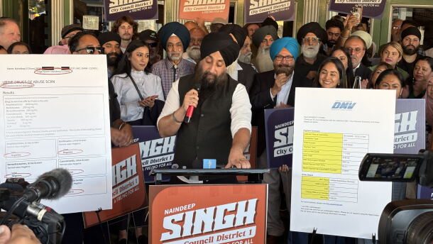 Naindeep Singh, center, speaks during a press conference outside the Tower Theater in Fresno, Calif., on Monday, Oct. 26, 2026, where he countered claims by Fresno police that he drove under the influence of a drug days earlier.