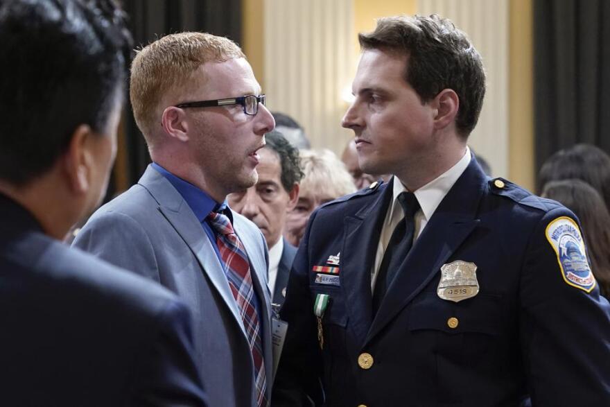 Stephen Ayres, left, shakes hands with Washington Metropolitan Police Department officer Daniel Hodges.