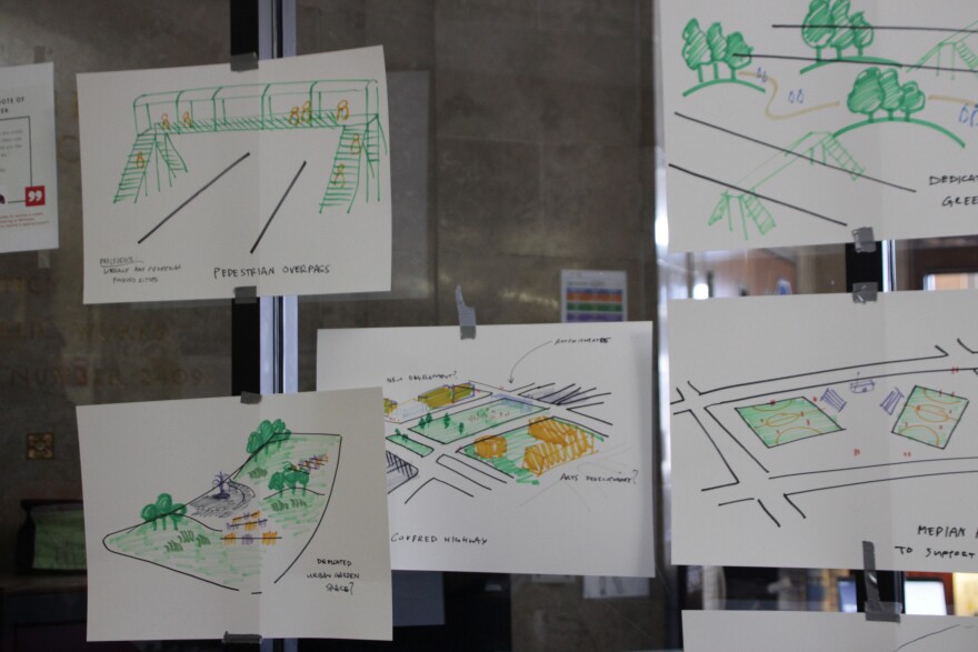 Five sketch drawings are taped to a clear board.