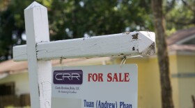 A "For Sale" sign is posted in the front lawn of a newly constructed home in East Tampa.