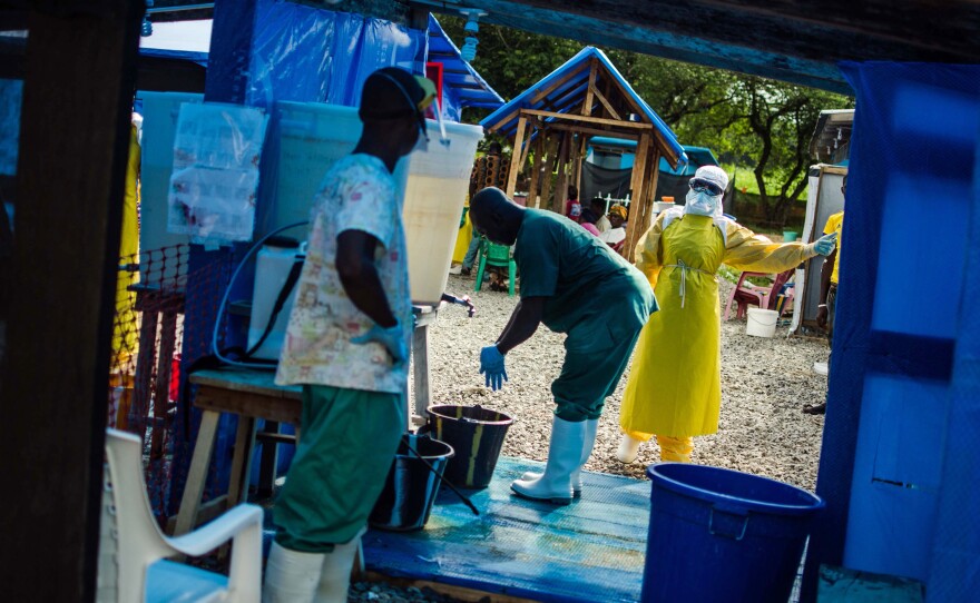 A health worker prepares to exit the isolation area at the Ebola clinic run by Doctors Without Borders in Lofa County, Liberia. The exponential growth of the outbreak is most aggressive in Liberia.