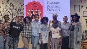 A group of people standing together in a room,