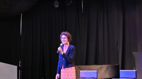 University of Tulsa professor of economics Clara Mattei stands on stage to speak to Tulsa residents during a forum organized by the Forum for Real Economic Emancipation.