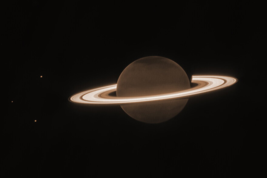 This June 2023 image provided by the Space Telescope Science Institute shows the planet Saturn and three of its moons, from left, Enceladus, Tethys and Dione, captured by the James Webb Space Telescope.