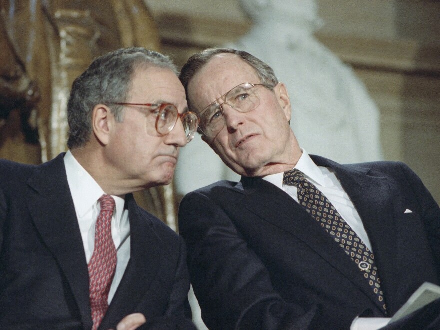 President George H.W. Bush, seen with Senate Majority Leader George Mitchell, D-Maine, in 1991, was punished at the ballot box for compromises that produced a budget-reduction act in 1990.