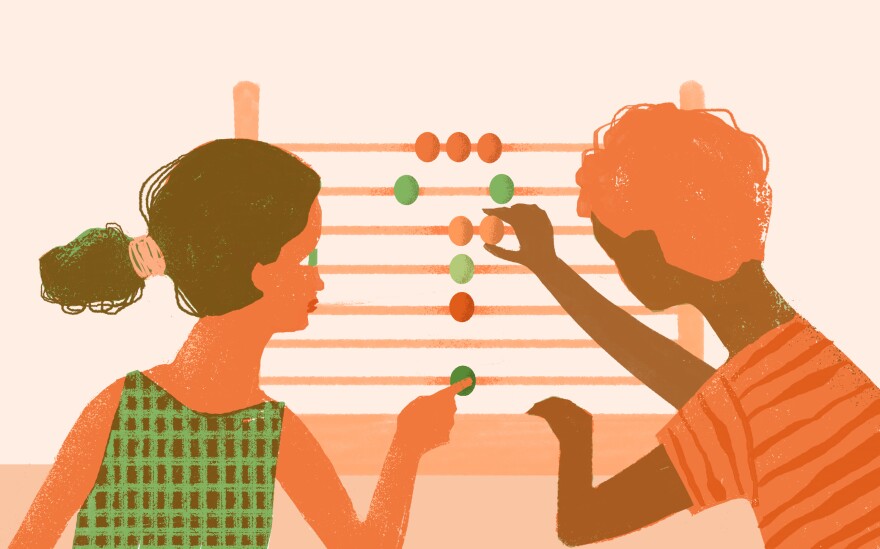 Students make a question mark with an abacus.