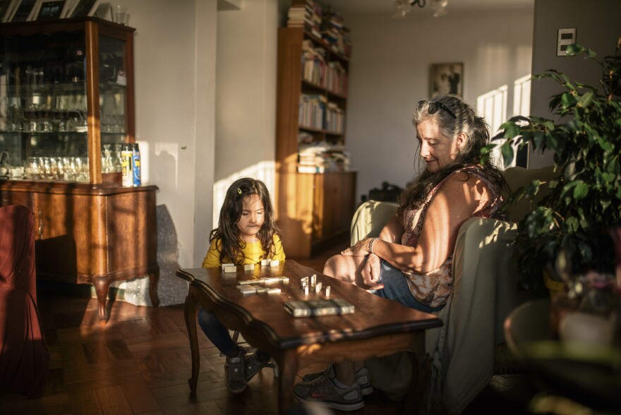 Cooped up together during the pandemic, Paz Olivares Droguett's mother and eldest daughter, Eleanora, find solace in a game of dominoes. Says Droguett: "During this time of confinement, board games have played a big part in our new family rituals." <em>March 20. Valparaíso, Chile.</em>