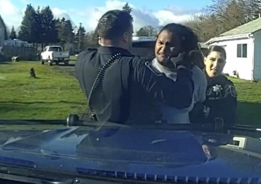 A former Eugene Police Officer appears to punch