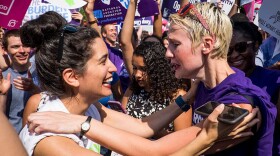 Abortion rights activists Morgan Hopkins of Boston, left, and Alison Turkos of New York City, celebrate on the steps of the United States Supreme Court on June 27, 2016 in Washington, DC. In a 5-3 decision, the U.S. Supreme Court struck down one of the nation's toughest restrictions on abortion, a Texas law that women's groups said would have forced more than three-quarters of the state's clinics to close. (Pete Marovich/Getty Images)