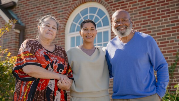 Dara Eskridge, center, stands alongside her parents Melody Eskridge, left, and Bobby Eskridge, right, outside of their home on Tuesday, Oct. 21, 2025, in University City. Invest STL’s Dara Eskridge was named to the Time100 NEXT list for her response efforts after May’s deadly EF3 tornado that ripped through north St. Louis.