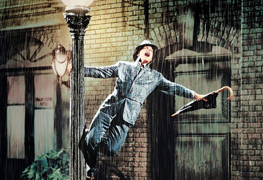 Actor Gene Kelly, twisting around a lamp post from the movie 'Singin' in the Rain.'