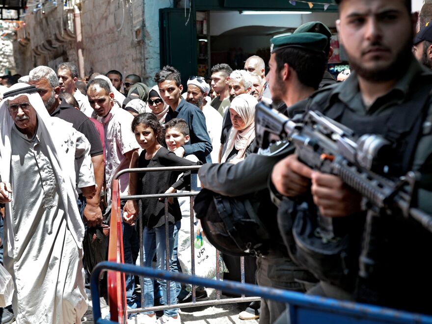 Israeli police stand guard in the main street of the Muslim Quarter of Jerusalem's Old City after Palestinian worshippers at Al-Aqsa Mosque took part in the first Friday prayers of the holy month of Ramadan.