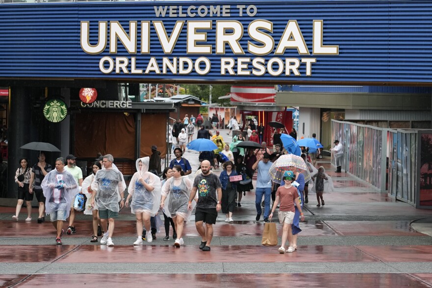 Tourists exit Universal Orlando Resort as they were closing early for the arrival of Hurricane Milton Wednesday, Oct. 9, 2024, in Orlando, Fla.