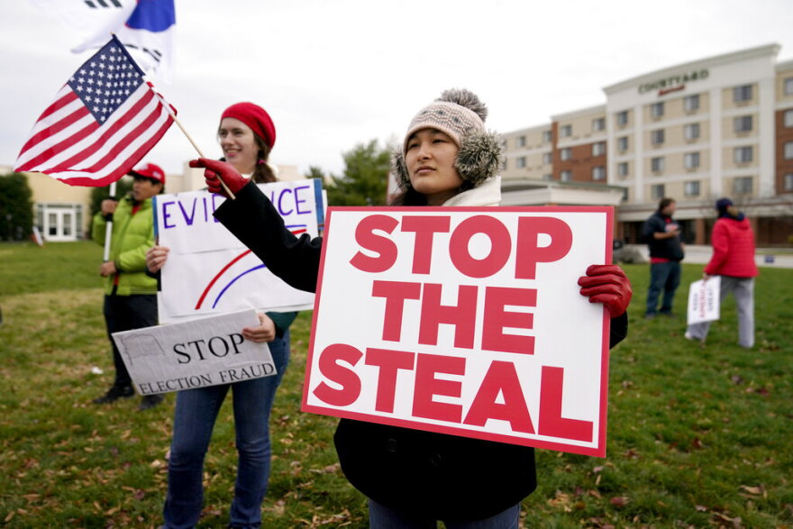 Supporters of President Donald Trump gather outside of the Wyndham Hotel where the Pennsylvania State Senate Majority Policy Committee is scheduled to meet, Wednesday, Nov. 25, 2020, in Gettysburg, Pa. (AP Photo/Julio Cortez)