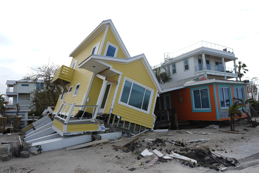 FILE - A house lies toppled off its stilts after the passage of Hurricane Milton, in Bradenton Beach on Anna Maria Island, Fla., Oct. 10, 2024.