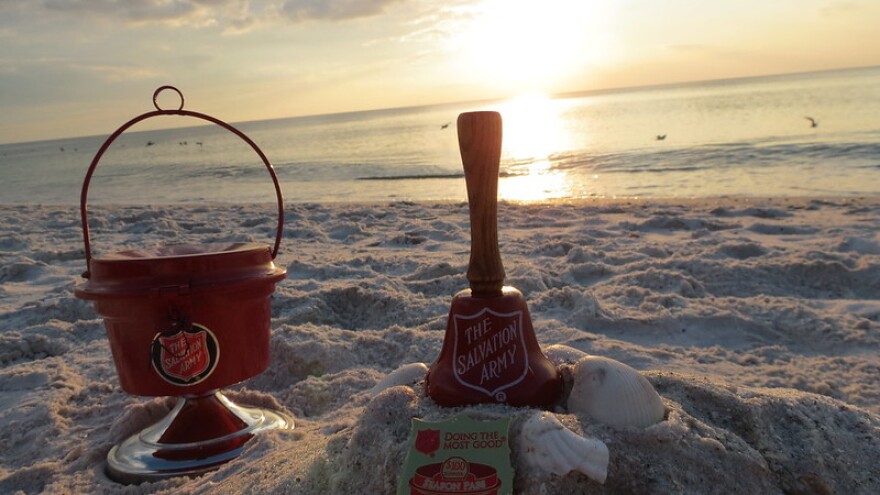 Iconic Salvation Army Mini Red Kettle and bell at Delnor-Wiggins Pass State Park at Sunset.