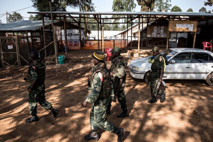 Soldiers from the Armed Forces of Democratic Republic of the Congo outside an Ebola Treatment Center in Butembo.