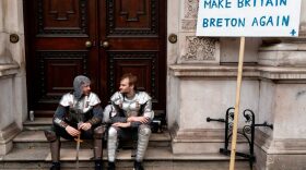 Two protesters dressed as medieval knights take a break after attending a march and rally organised by the pro-European People's Vote campaign.