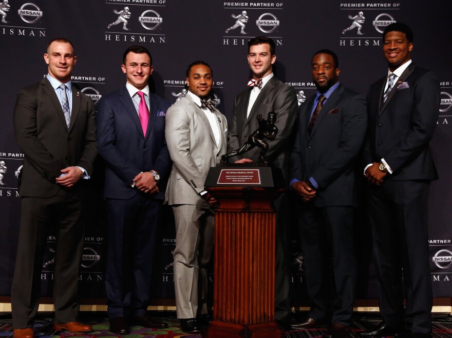 The Heisman Trophy finalists pose with the award Saturday. From left are Northern Illinois quarterback Jordan Lynch, Texas A&M quarterback Johnny Manziel, Auburn running back Tre Mason, Alabama quarterback AJ McCarron, Boston College quarterback Andre Williams and Florida State quarterback Jameis Winston.