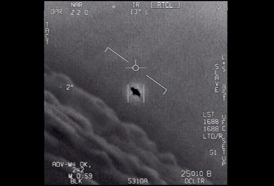 The image from video provided by the Department of Defense labelled Gimbal, from 2015, an unexplained object is seen at center as it is tracked as it soars high along the clouds, traveling against the wind. “There's a whole fleet of them,” one naval aviator tells another, though only one indistinct object is shown. “It's rotating." The U.S. government has been taking a hard look at unidentified flying objects, under orders from Congress, and a report summarizing what officials know is expected to come out in June 2021. (Department of Defense via AP)